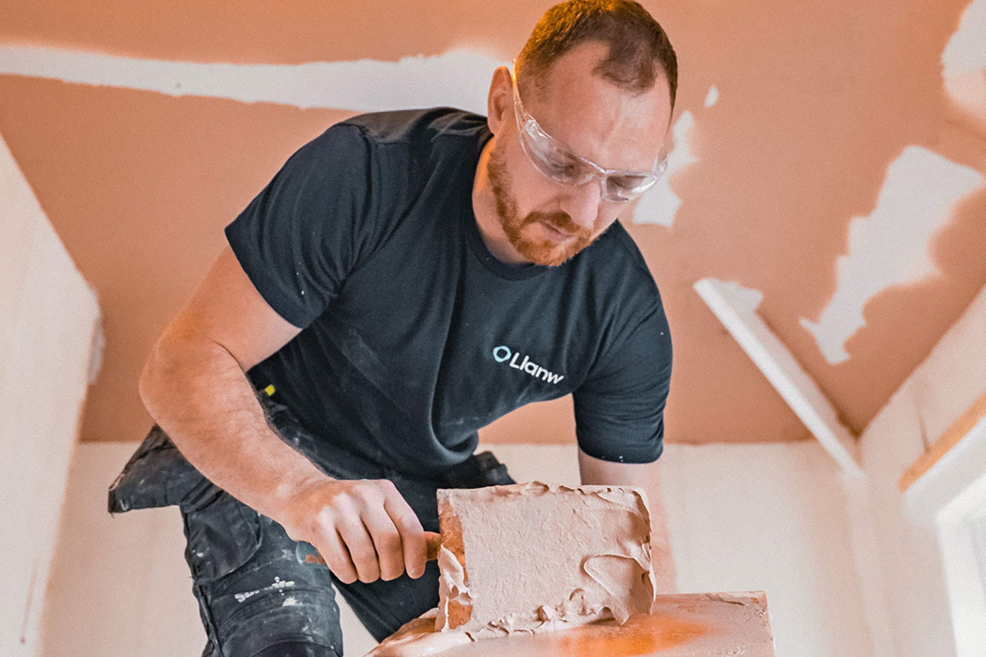 Plasterer with safety goggles